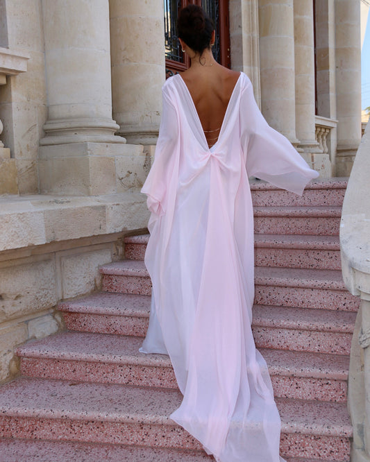 women wearing pink Delfino Cape on steps